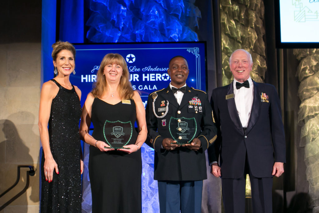 Two women and two men smiling, accepting awards.