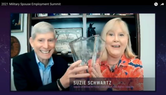 Suzie Schwartz holding the Bonnie Amos Impact Award for Lifetime Achievement