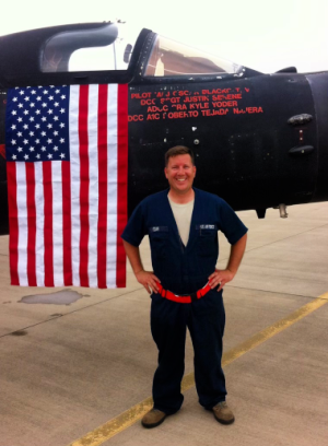 Air Force crew chief Michael Coar stands in front of fighter jet