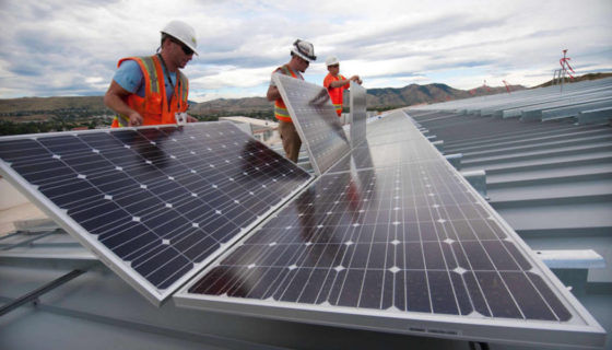 Workers working on a solar panel