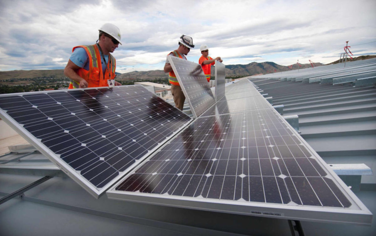 Workers working on a solar panel