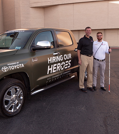 HOH President Eric Eversole and Paralympic medalist Brad Snyder standing next to a new Toyota truck