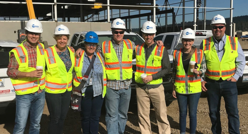 A group of workers wearing hard hats