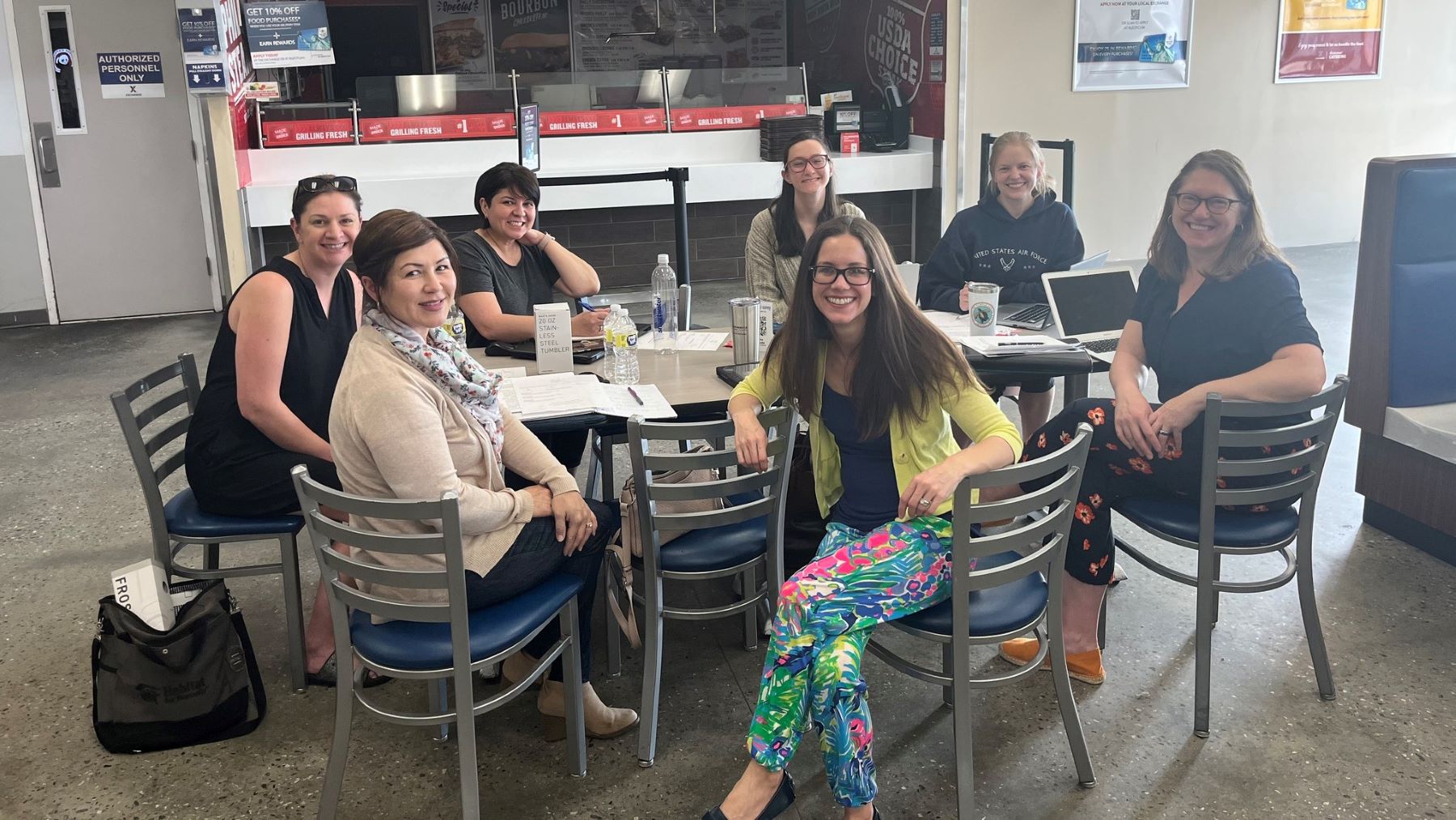 A group of military spouses sit at a table