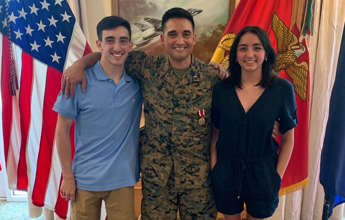 Marine standing front of flags