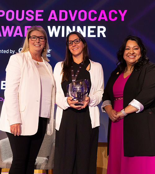 Senior Program Manager, Amazon, Nicole Morrison (center) receives the Military Spouse Advocacy Impact Award during the Hiring Our Heroes Military Spouse Employment Summit 2025.