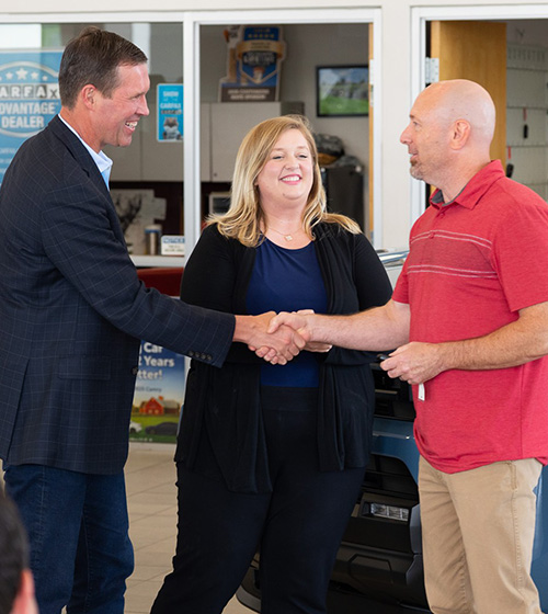 2025 Toyota Giveaway winner shaking hands with Hiring Our Heroes president Eric Eversole with a representative from Toyota nearby.