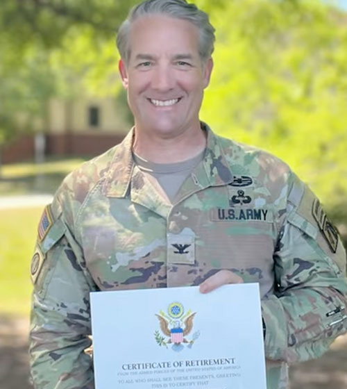 Army veteran John Herrman pictured here smiling holding a certificate of retirement, went from HOH fellow to tech startup co-founder.