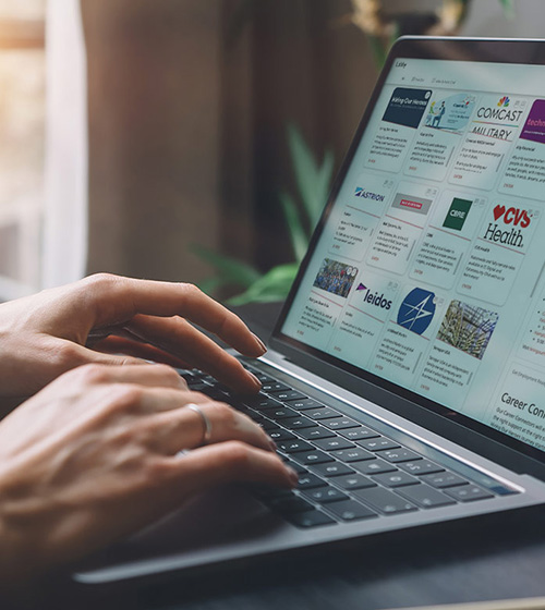 virtual events header image of a woman using a laptop in from of a window