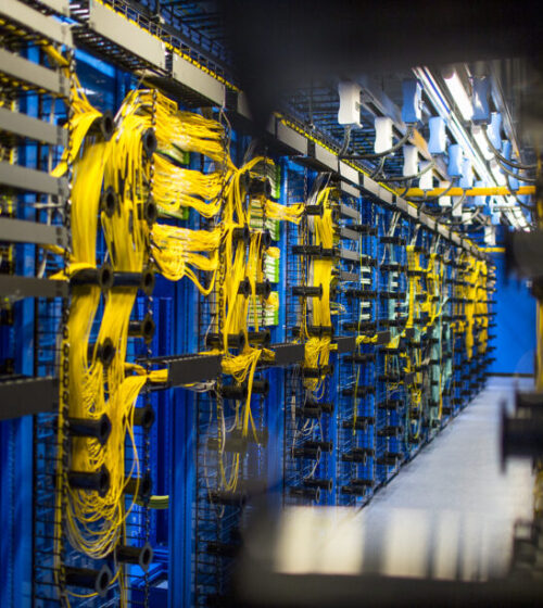 photo of networking cables neatly routed through equipment in a data center