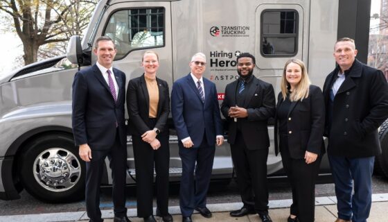 2025 Transition Trucking Award winner Charles Jones, Jr. poses in front of his new truck with award presenters.