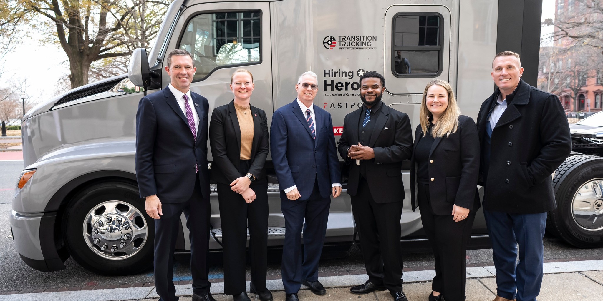 2025 Transition Trucking Award winner Charles Jones, Jr. poses in front of his new truck with award presenters.