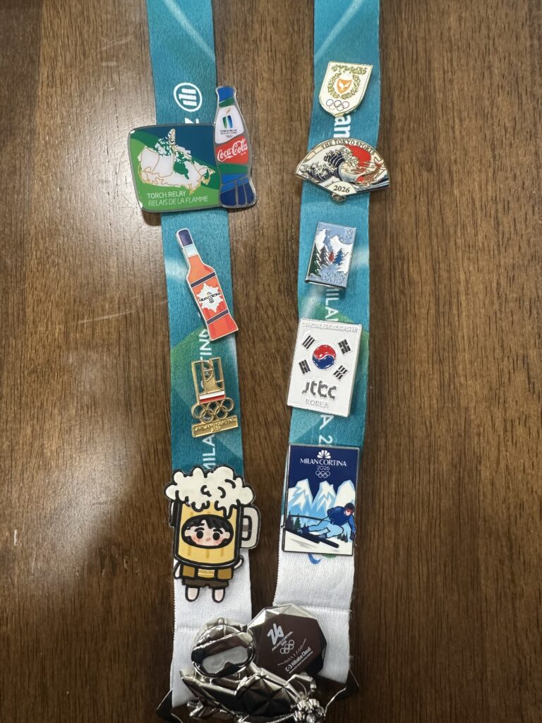 Anuar Pinto Velasco's lanyard with all of the Olympics pins he received while working at the 2026 Winter Olympics.