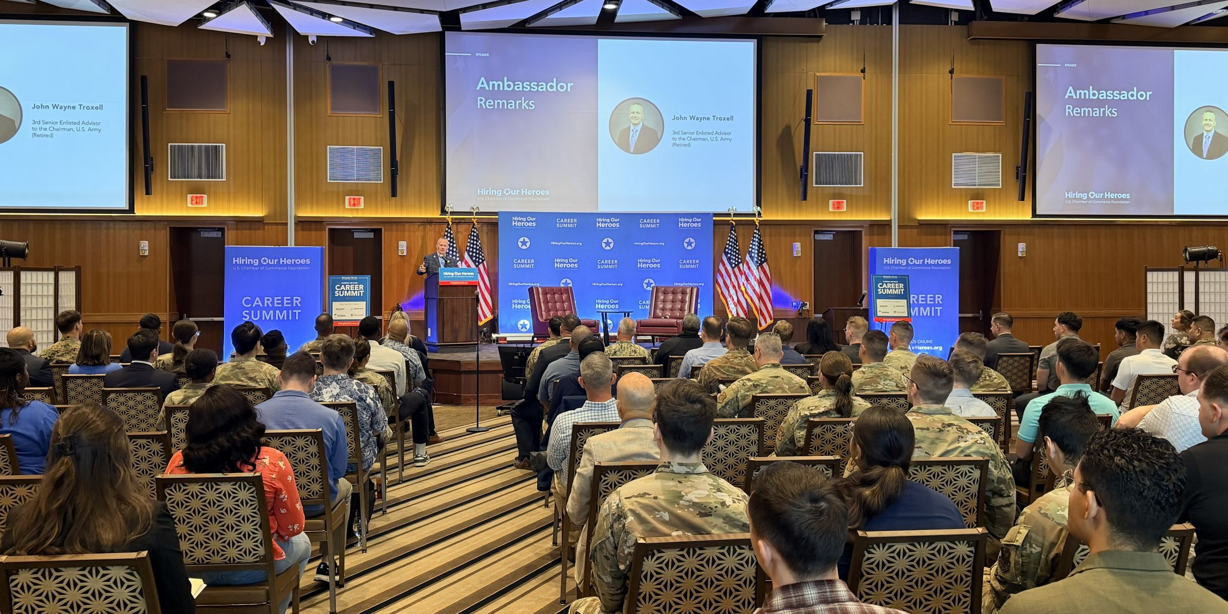 Ambassador John Wayne Troxell delivers remarks to an audience of service members and civilians at the 2026 Career Summit at Kadena Air Force Base.