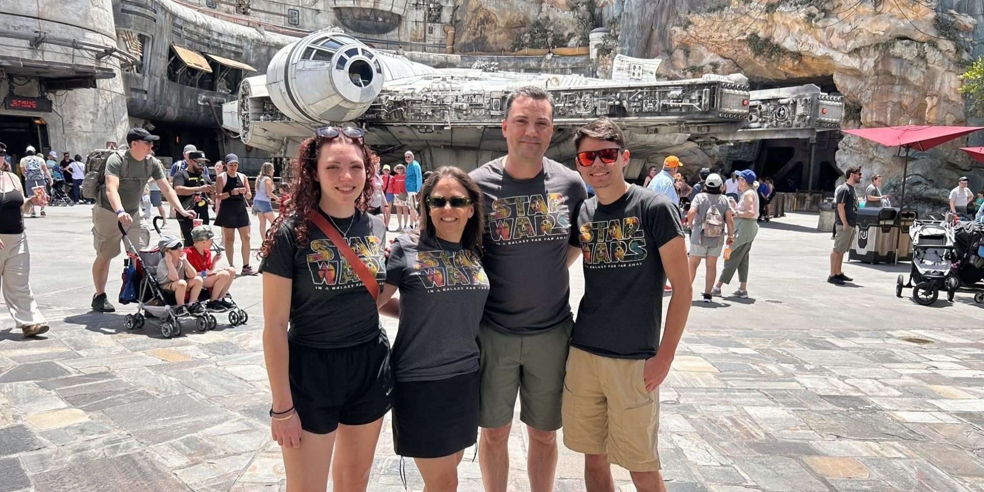 John Melendez and his family pose in front of the Millennium Falcon at Disney World