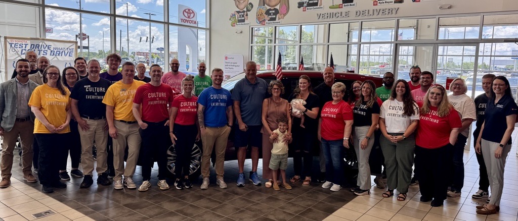 Steve Lawrence and family pose with the staff of Toyota of Muncie and HOH's Brooke Prouty in front of his new Toyota Highlander during the Committed to America's Heroes Sweepstakes ceremony.