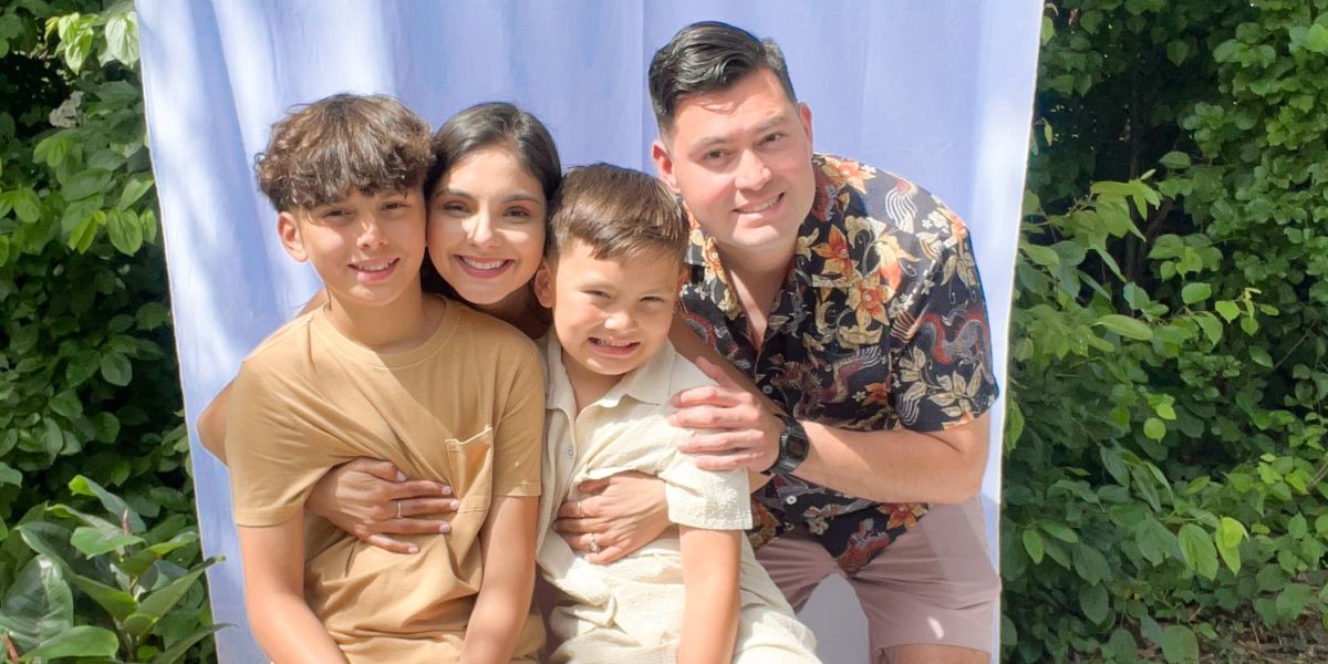 Marina poses with her husband and two children.