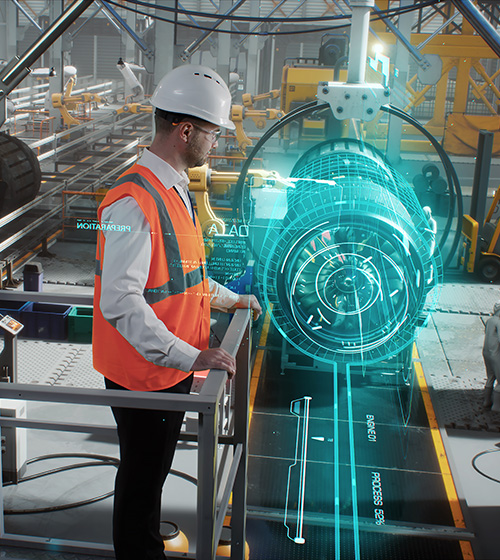 Man in a hard hat and orange safety vest inspects a piece of hardware in a manufacturing facility.