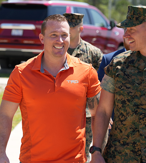 Dakota Meyer, Medal of Honor Recipient, smiling, walking with men in uniform.
